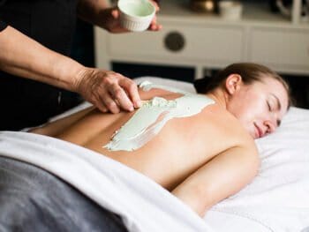 marine algae body wrap being applied to a woman in our spa