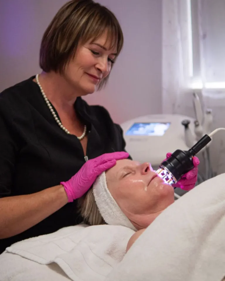 Esthetician Kim Performing Cold Laser Therapy on a Mature Woman