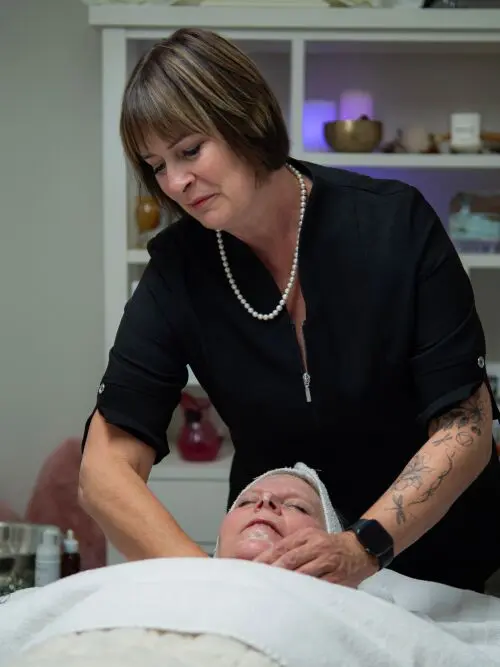 Esthetician Performing Facial on a Woman in the Spa