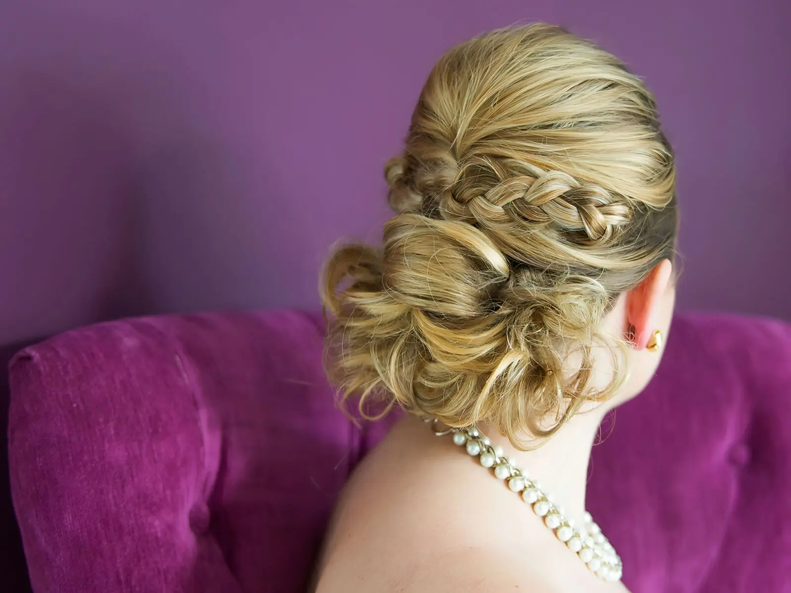 Woman turns away from camera to show her new hairstyle at the hair salon