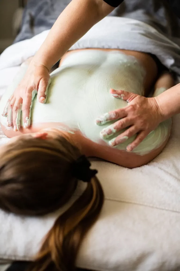 marine algae body wrap being applied to back